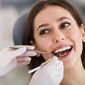 young woman getting her teeth cleaned