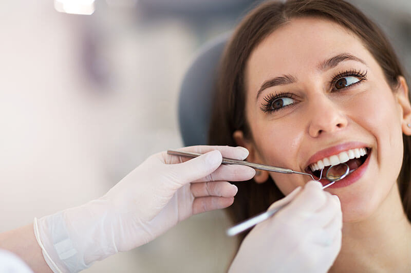 young woman smiling during a dental checkup