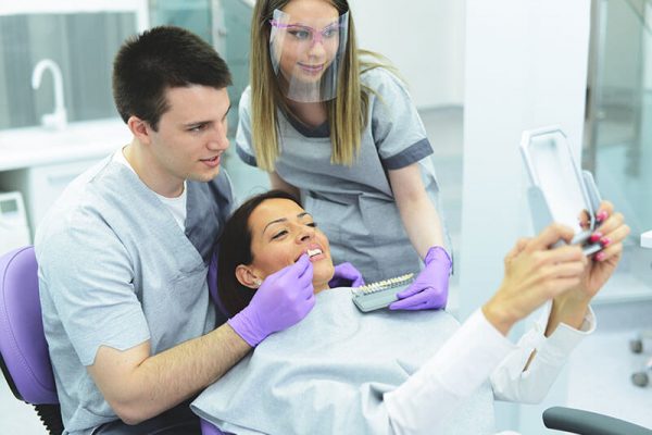 Happy female patient getting porcelain veneers